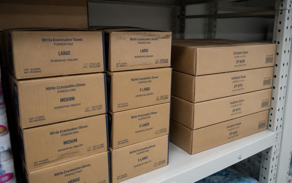 Rows of sterile nitrile gloves and clinical consumables in storage